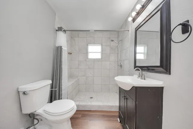 a bathroom with a sink a mirror and a shower