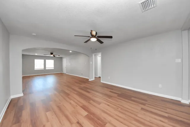 wooden floor in an empty room with a window