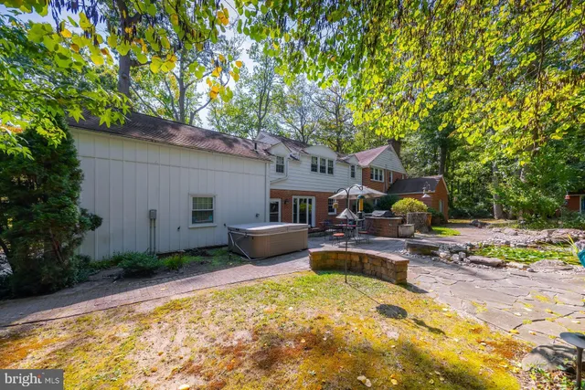 a front view of a house with swimming pool and sitting area