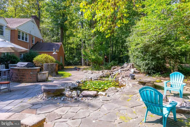 a view of a patio with chairs and potted plants