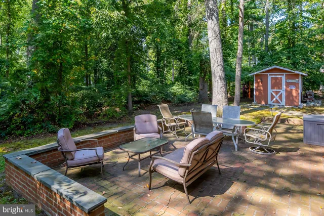 a view of a backyard with furniture and garden