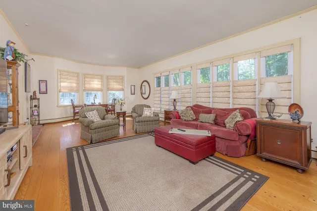 a living room with furniture fireplace and a window