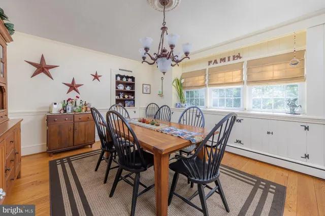 a view of a dining room with furniture and a chandelier