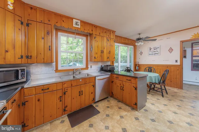 a kitchen with stainless steel appliances a stove a sink and a refrigerator