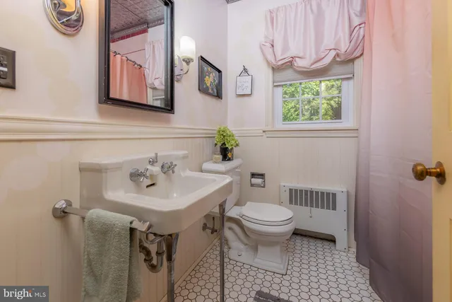 a hallway with wooden floor and windows