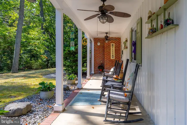 a view of a patio with chair and tables back yard of the house