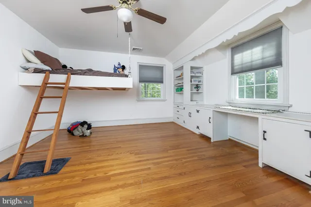 an empty room with a window and a ceiling fan