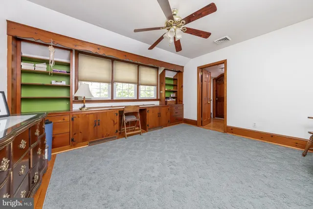 a living room with furniture and a kitchen area