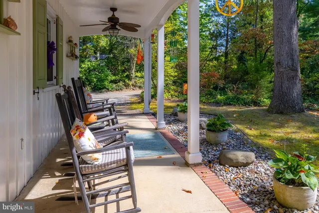 a view of a backyard with sitting area and garden