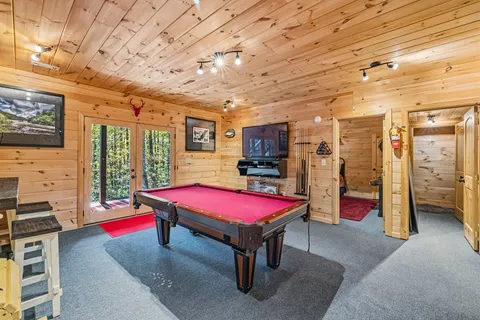 a room with pool table and flat screen tv