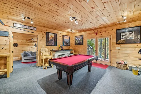 a living room with furniture a flat screen tv and a table