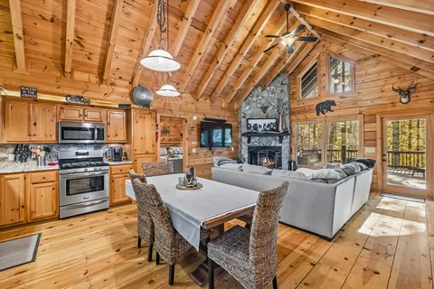 a living room with fireplace furniture and a kitchen view