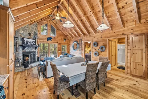 a living room with furniture a fireplace and a table