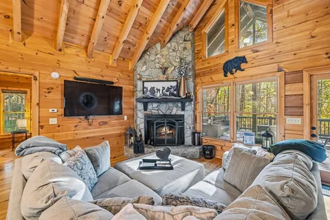 a living room with furniture a fireplace and a flat screen tv