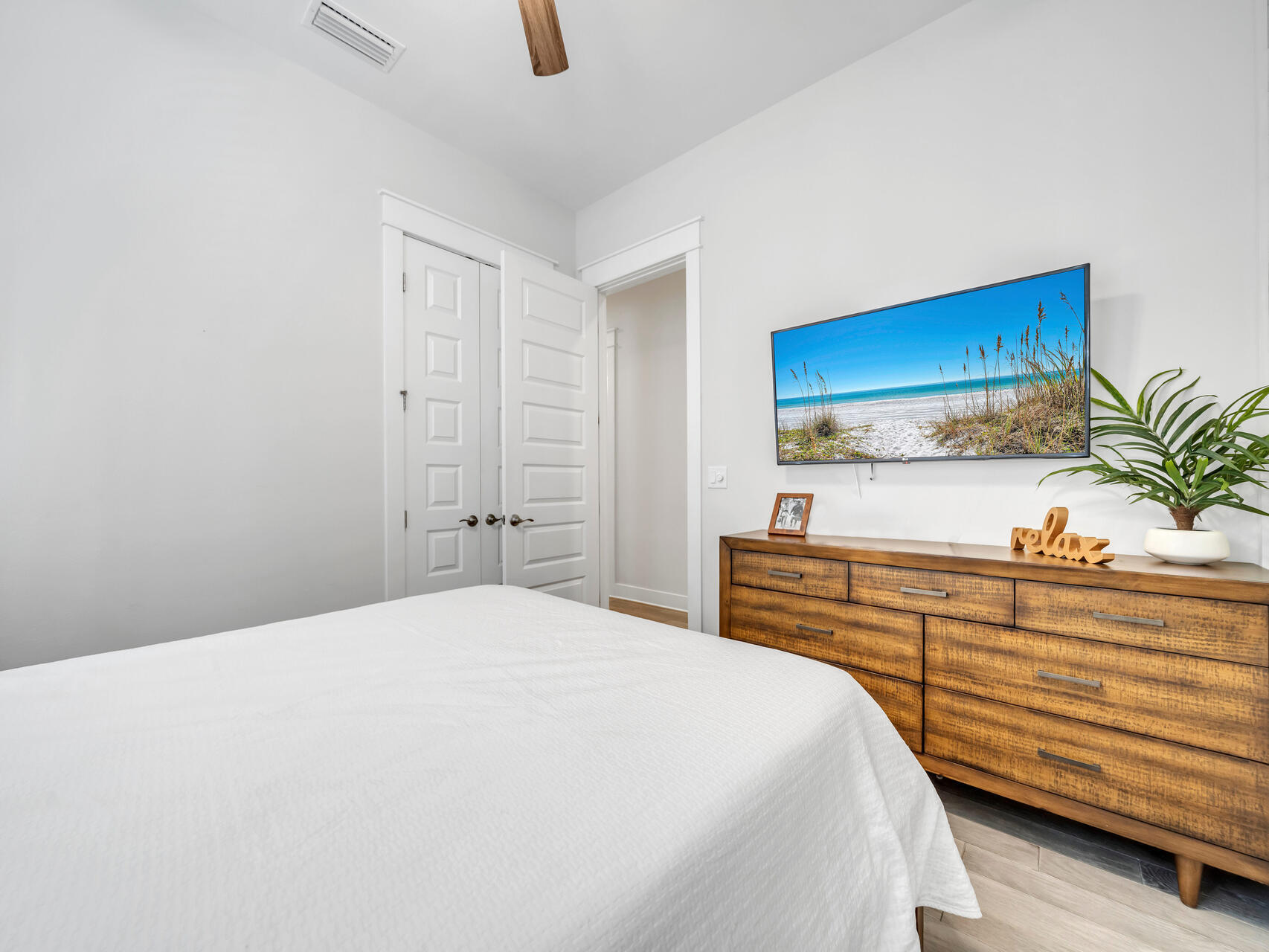 299 Milestone Dr Inlet Beach, Unit A Inlet Beach, FL 32461 - Photo 24 of 41 a bedroom with a bed and a potted plant