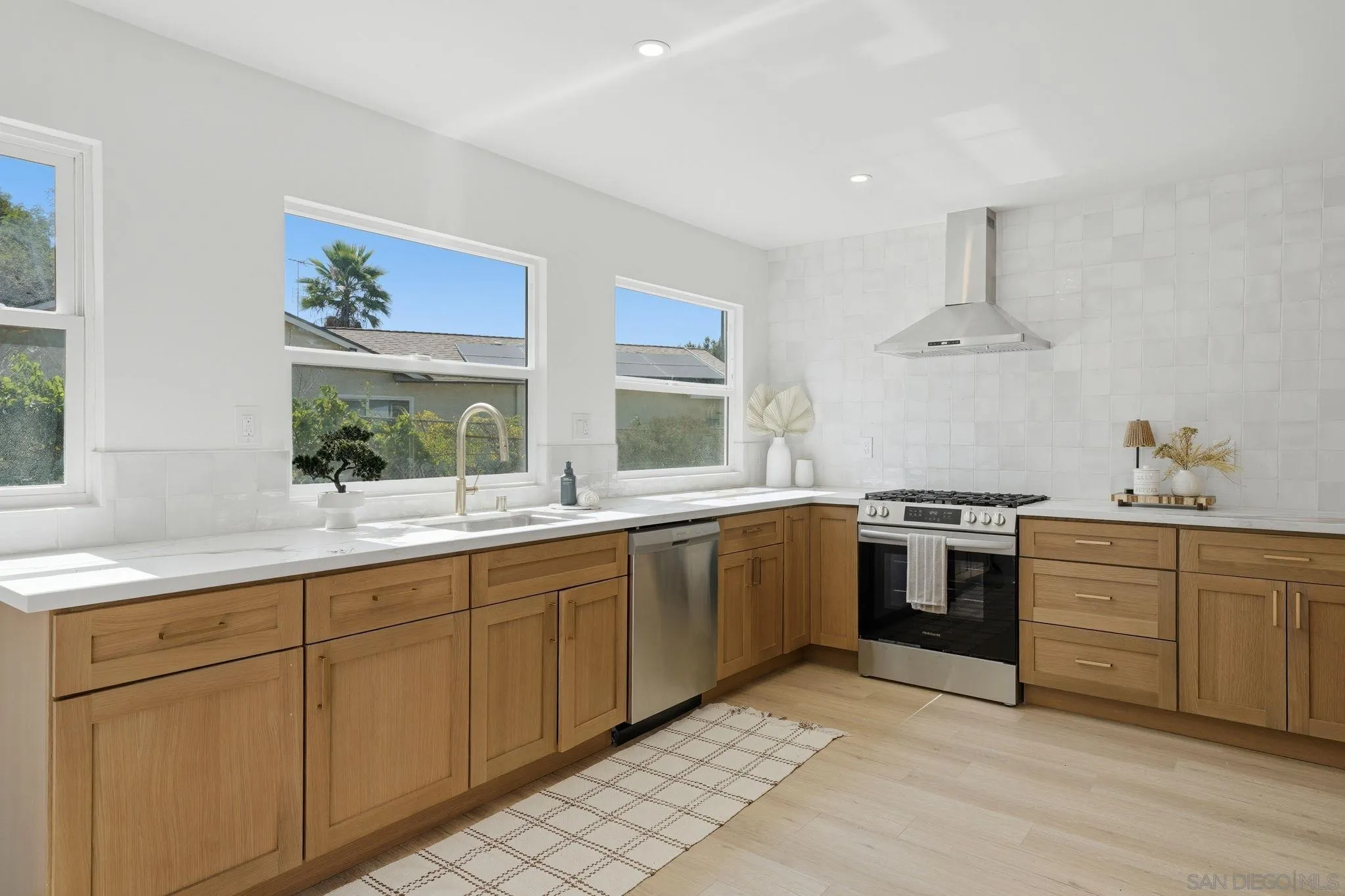 10440 Bosque Drive Lakeside, CA 92040 - Photo 13 of 47 a kitchen with a sink and stove
