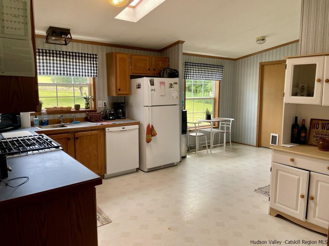 302 Springfield Hill Road Cooperstown, NY 13326 - Photo 7 of 19 a kitchen with a stove a refrigerator and a sink