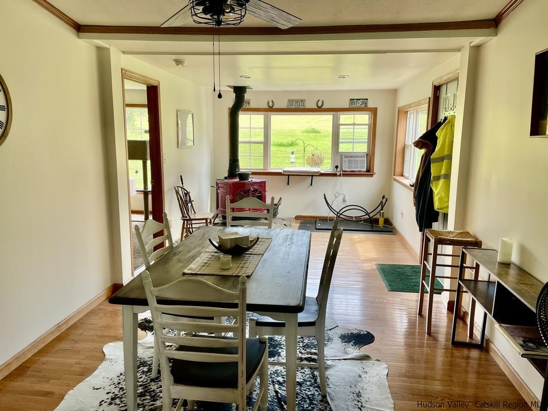 302 Springfield Hill Road Cooperstown, NY 13326 - Photo 8 of 19 a view of a dining room with furniture and wooden floor