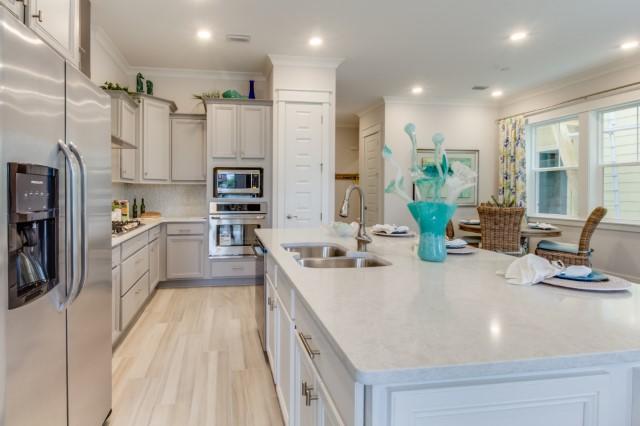 146 Pine Lands Loop Inlet Beach East, Unit A Inlet Beach, FL 32461 - Photo 1 of 42 a large kitchen with stainless steel appliances lots of counter space and a sink