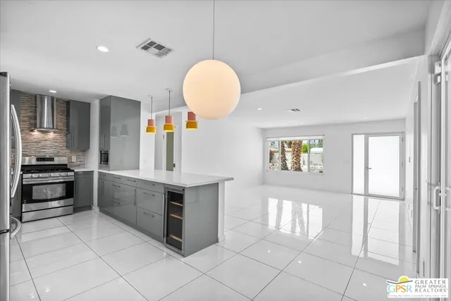 a kitchen with stainless steel appliances granite countertop a stove and a sink