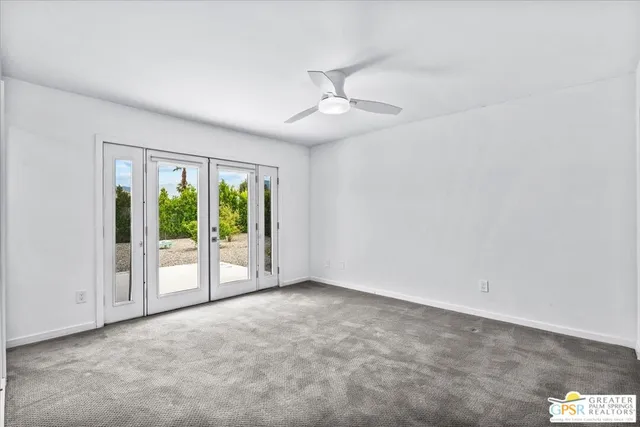 an empty room with windows and outdoor view