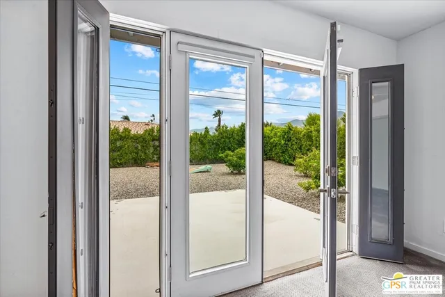 a view of a glass door and a large window