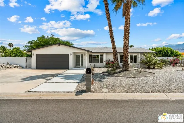 a front view of a house with garden and patio