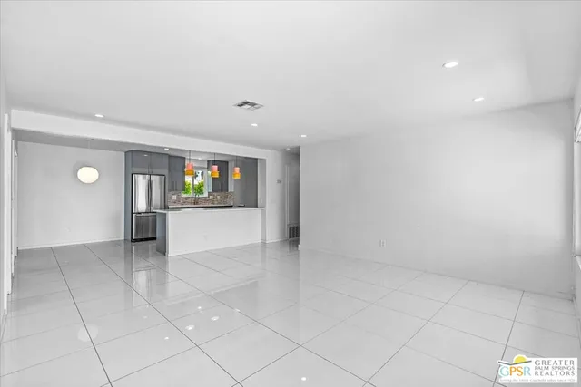 an empty room with windows and entrance