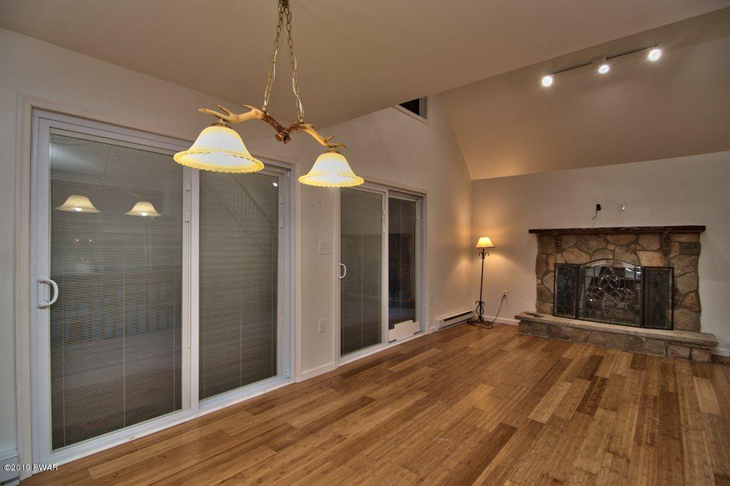 3145 Northgate Road Lake Ariel, PA 18436 - Photo 8 of 78 a view of a livingroom with a chandelier fan and a fireplace