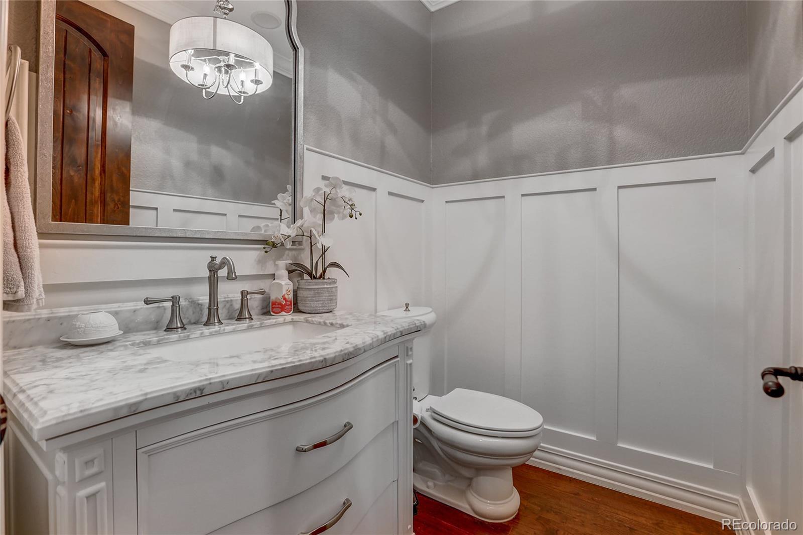 147 Commander Drive Erie, CO 80516 - Photo 11 of 50 a bathroom with a granite countertop sink a toilet and a mirror