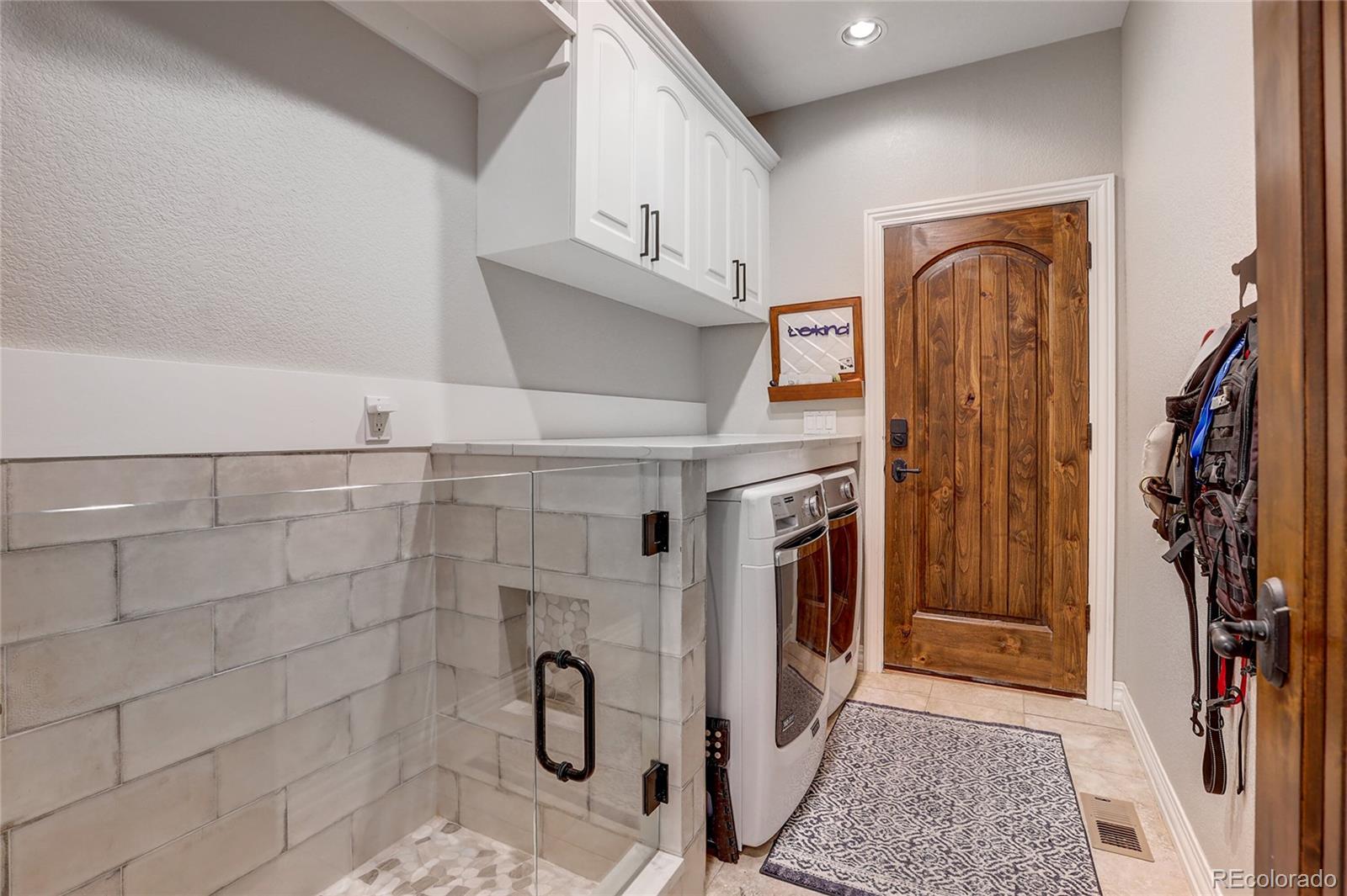 147 Commander Drive Erie, CO 80516 - Photo 13 of 50 a view of a storage & utility room with washer and dryer