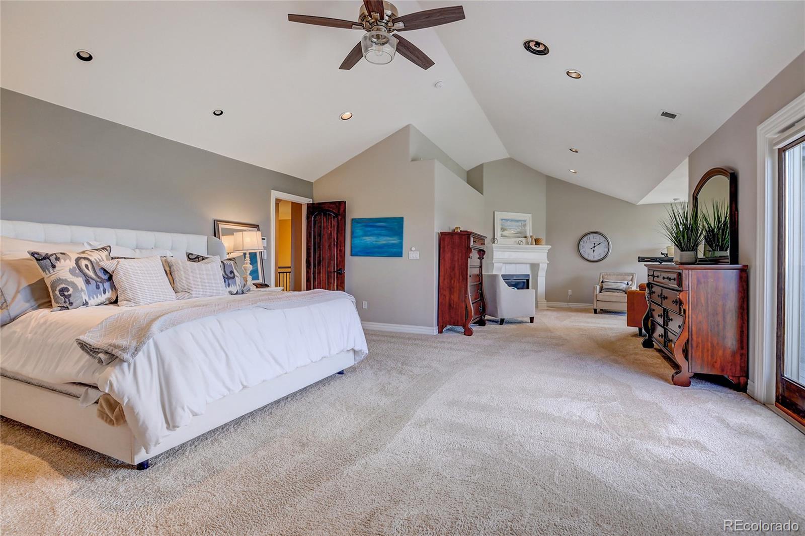 147 Commander Drive Erie, CO 80516 - Photo 16 of 50 a spacious bedroom with a bed and ceiling fan