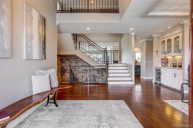 a kitchen with stainless steel appliances granite countertop a sink a stove a refrigerator and island with wooden floor