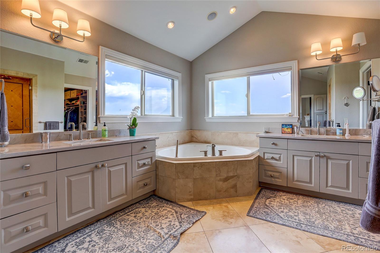 147 Commander Drive Erie, CO 80516 - Photo 21 of 50 a spacious bathroom with a tub double sink window and mirror