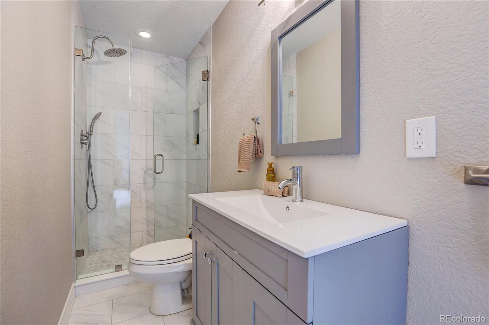 147 Commander Drive Erie, CO 80516 - Photo 24 of 50 a bathroom with a sink a toilet and shower