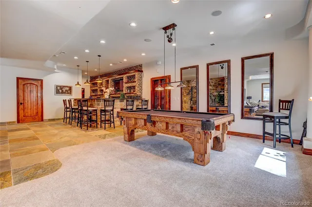a front view of a house with a big yard and potted plants
