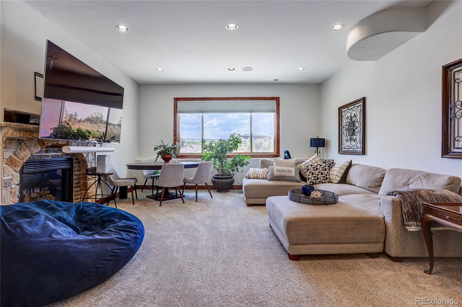 147 Commander Drive Erie, CO 80516 - Photo 29 of 50 a living room with furniture and a flat screen tv