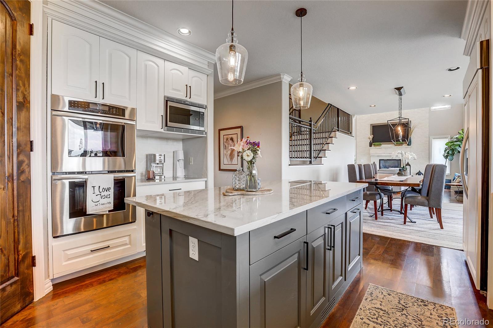 147 Commander Drive Erie, CO 80516 - Photo 6 of 50 a open kitchen with stainless steel appliances granite countertop a stove oven and a refrigerator with cabinets