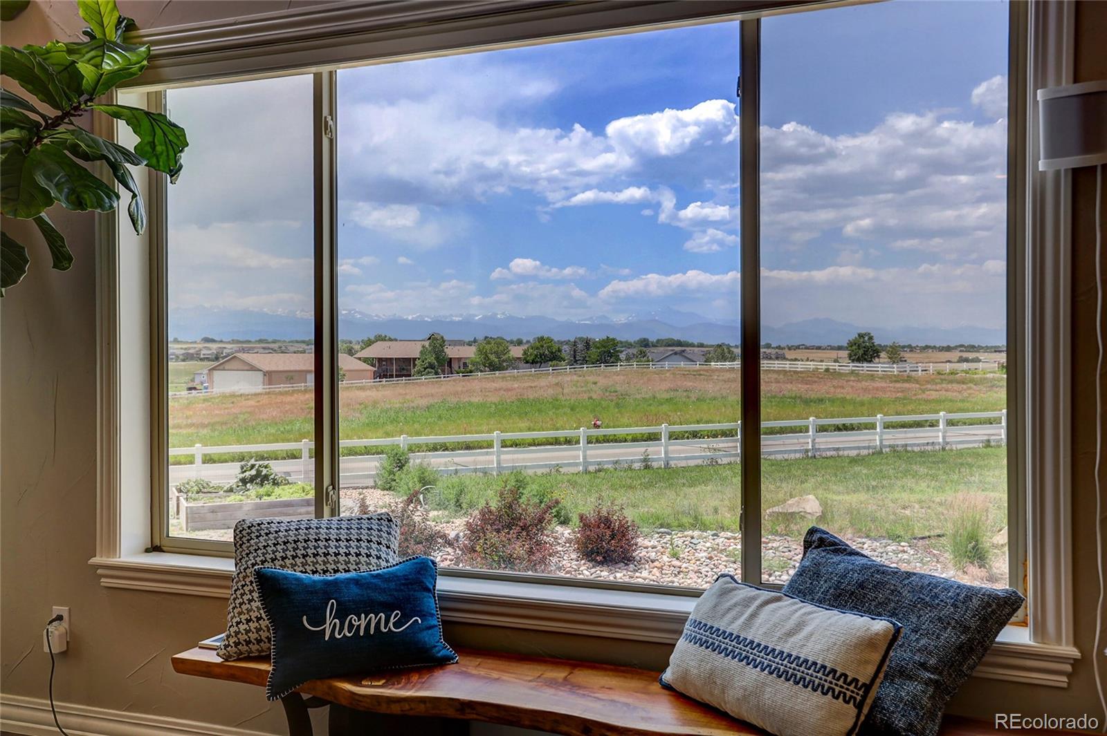 147 Commander Drive Erie, CO 80516 - Photo 8 of 50 a balcony with furniture and a floor to ceiling window