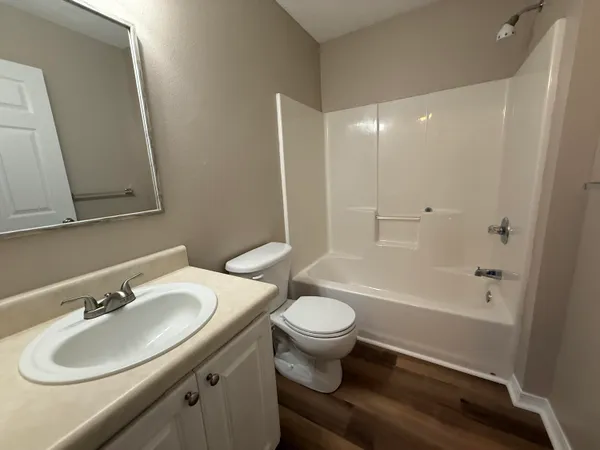 a bathroom with a sink toilet a mirror and shower