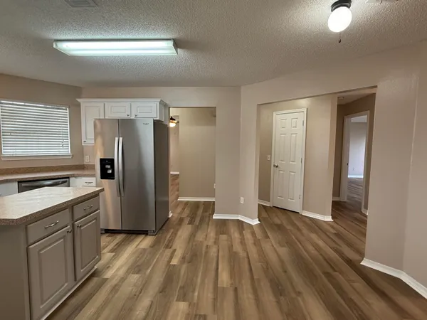 a kitchen with a refrigerator and a sink