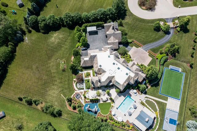 a front view of a house with a yard and plants