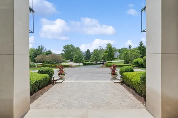 a view of a house with backyard fountain and sitting area