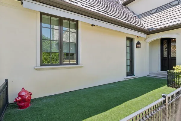 a front view of a house with swimming pool having outdoor seating
