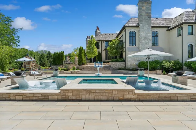 a sink with a granite countertop double vanity and a mirror