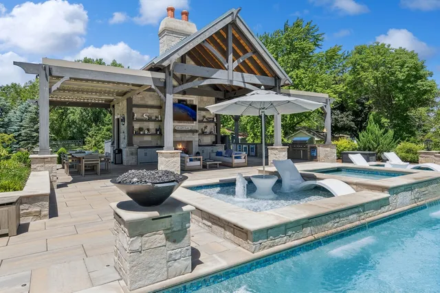 a kitchen with stainless steel appliances granite countertop white cabinets and window