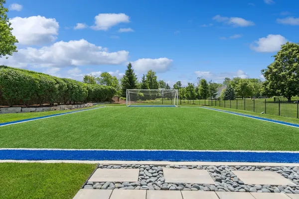 a living room with furniture a flat screen tv and a large window