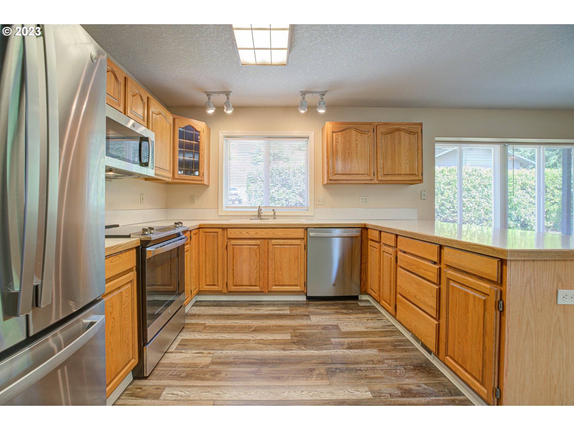 4523 Southeast Hill Road Milwaukie, OR 97267 - Photo 10 of 48 a kitchen with stainless steel appliances granite countertop a stove a sink and a refrigerator