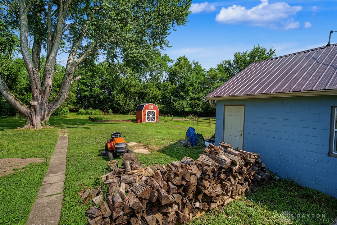 8707 Lytle Ferry Road Waynesville, OH 45068 - Photo 33 of 54 A spacious backyard with mature trees and a separate shed, offering ample outdoor living potential.