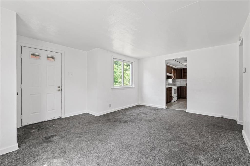 1012 Universal Road Pittsburgh, PA 15235 - Photo 3 of 13 an empty room with windows and closet